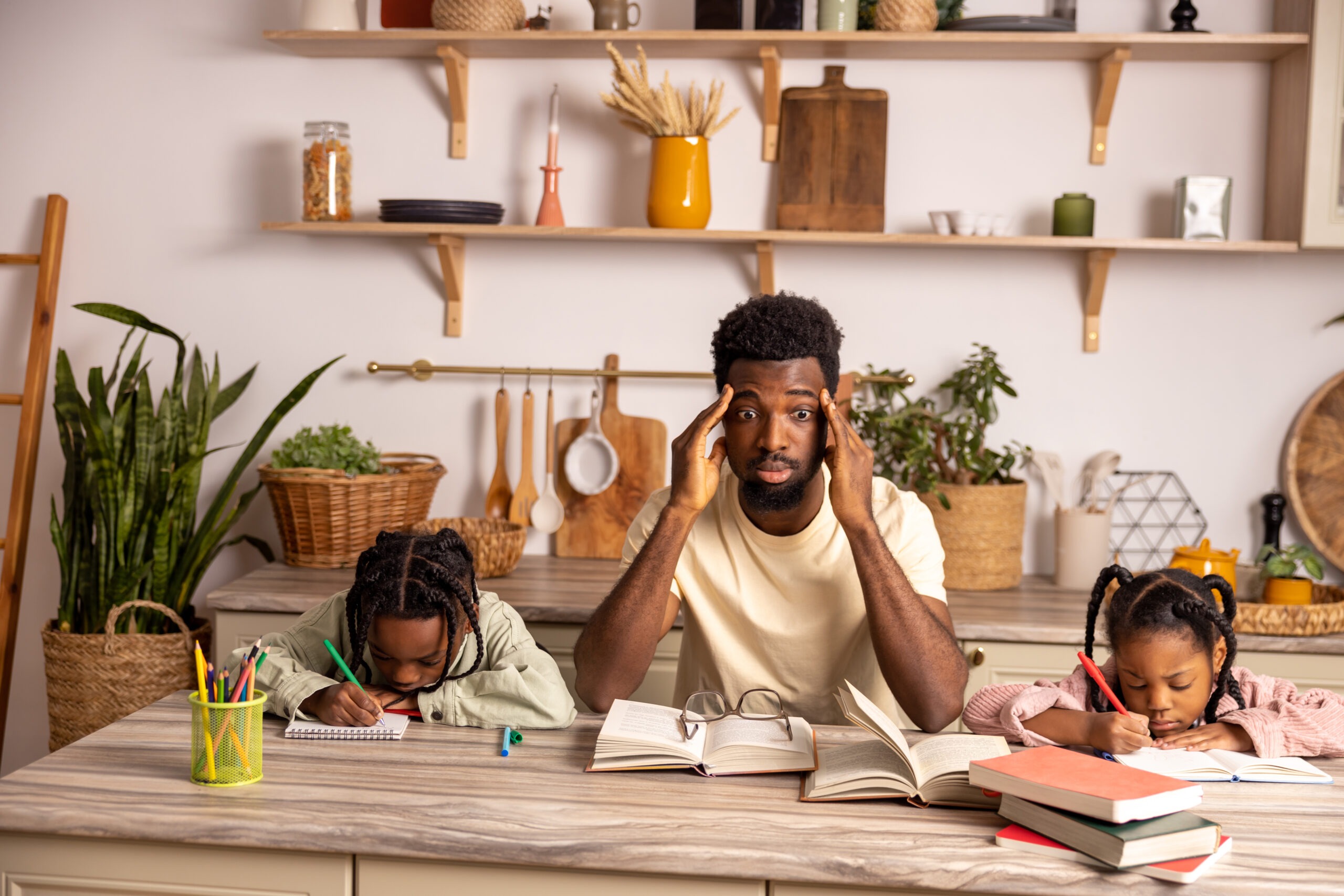 Tired father and children gathering around table doing kid's homework